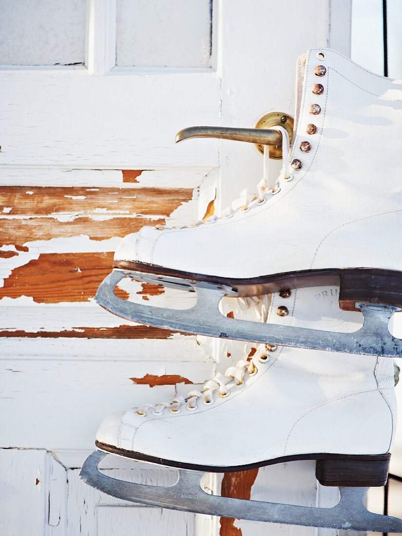 Ice skates hanging from shed door