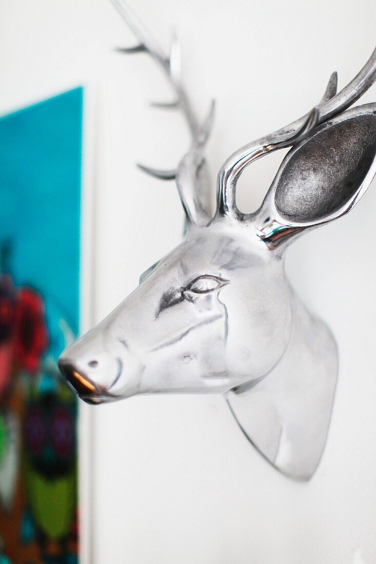 Chrome deer head on white wall
