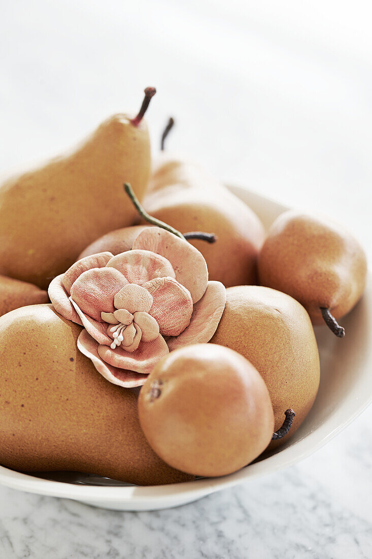 Bowl of fruit and fabric flower