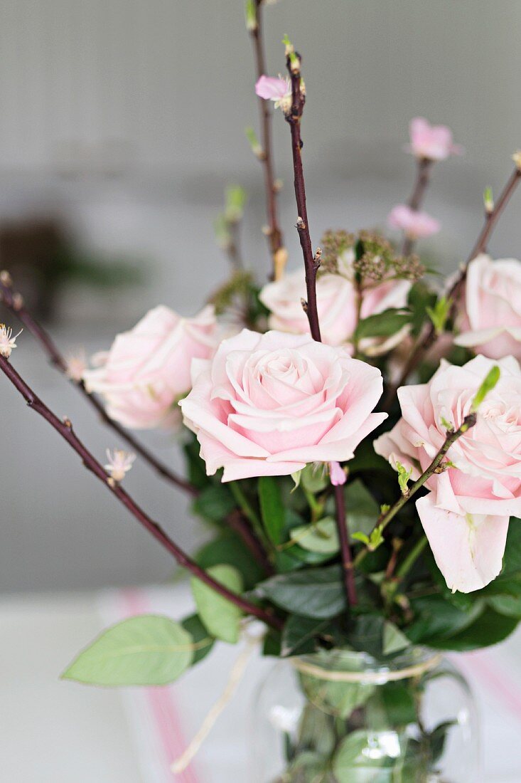 Bouquet of pastel roses with flowering branches