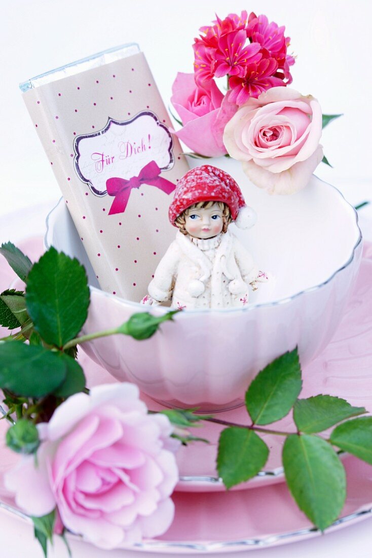 Chocolate, doll and roses in vintage bowl