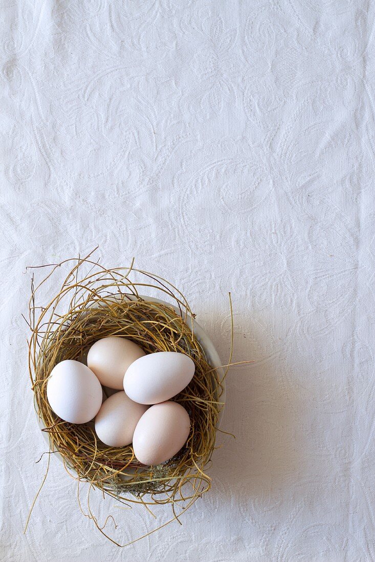 Unpainted eggs in Easter nest