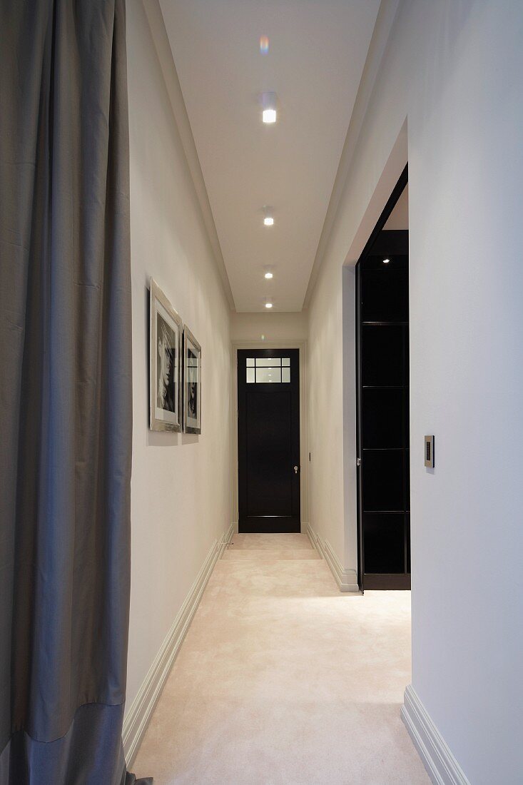 Narrow, minimalist hallway and wide passageway
