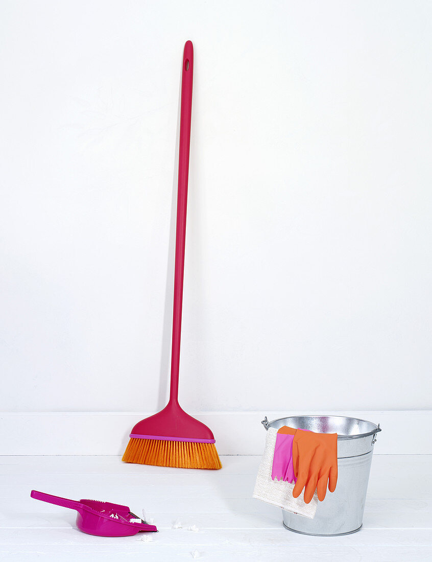 A zinc bucket, rubber gloves, a broom and a dustpan and brush