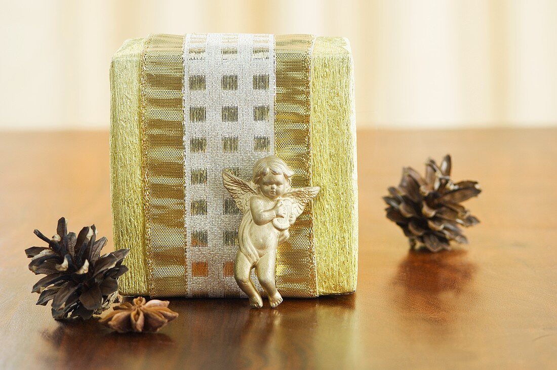 A Christmas present with a cherub, pine cones and star anise