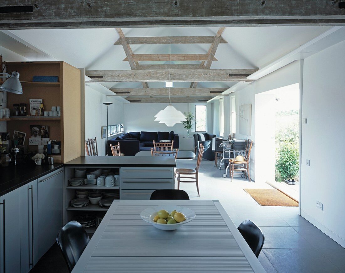 Open living room with dining room in the kitchen area in a converted barn