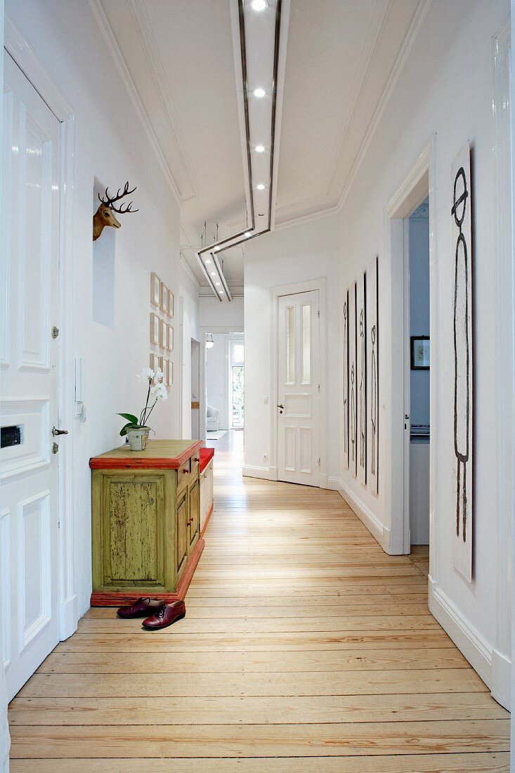 A hallway with a chest of drawers