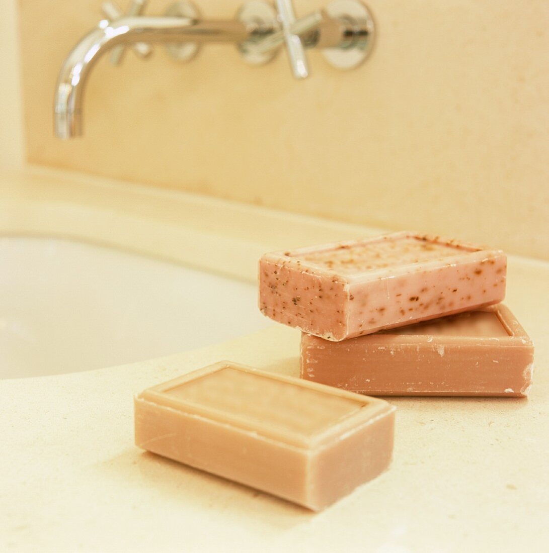 Bars of soap on a modern wash stand with wall taps