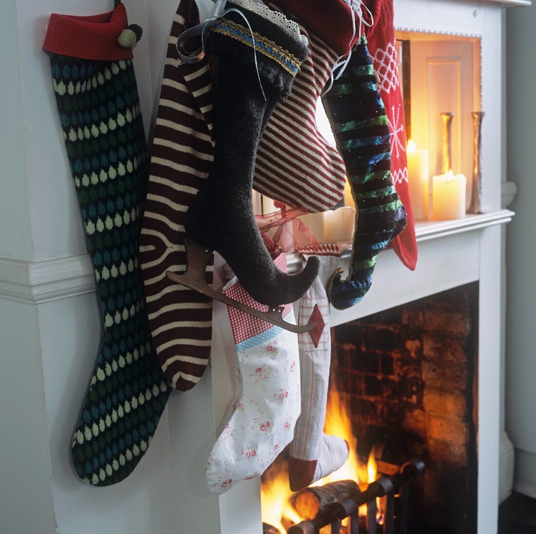 A collection of Christmas stockings hanging next to a fireplace