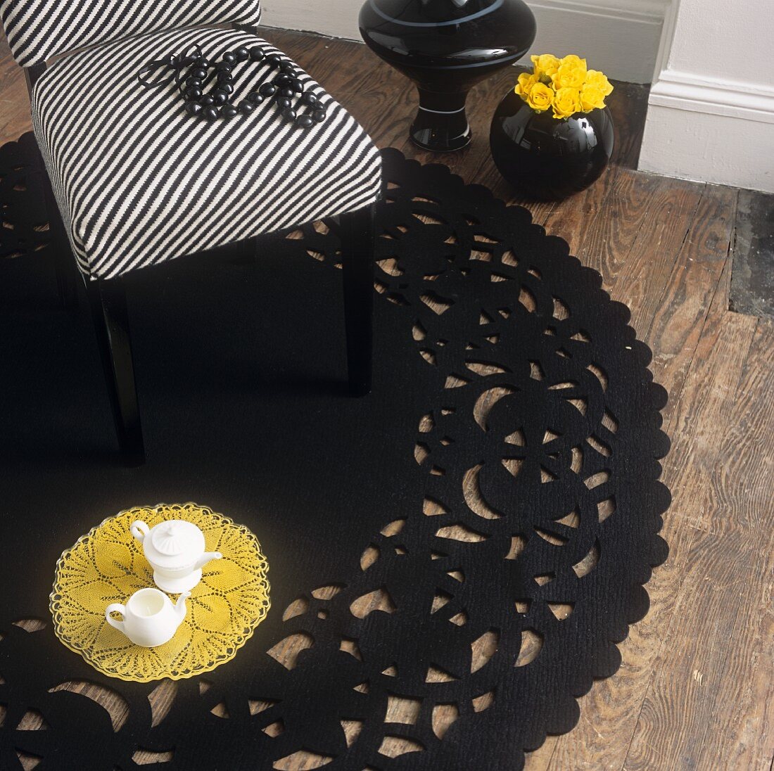 A chair with a striped cover on a round black rug
