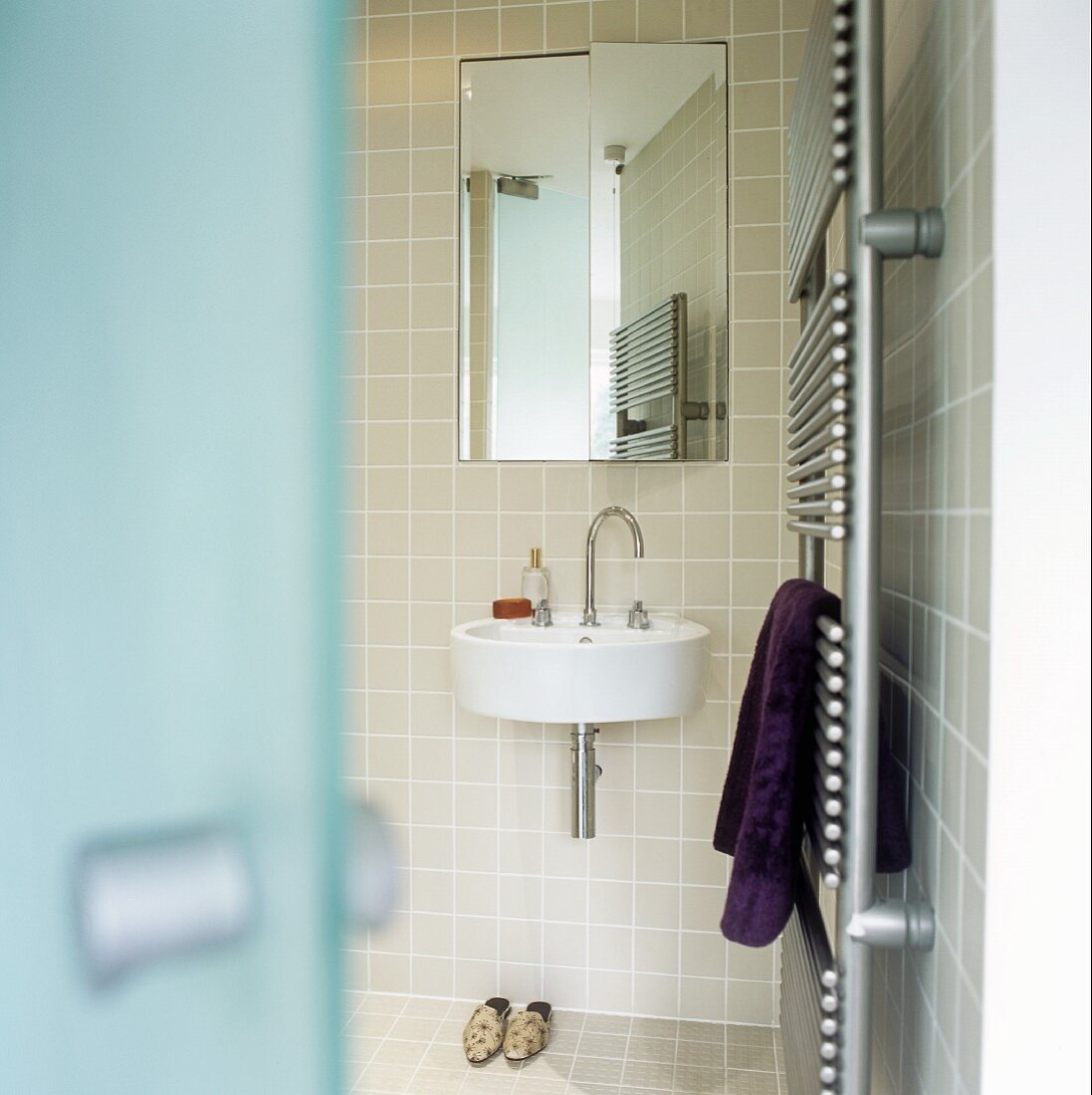 A view into a bathroom with a heated towel rail