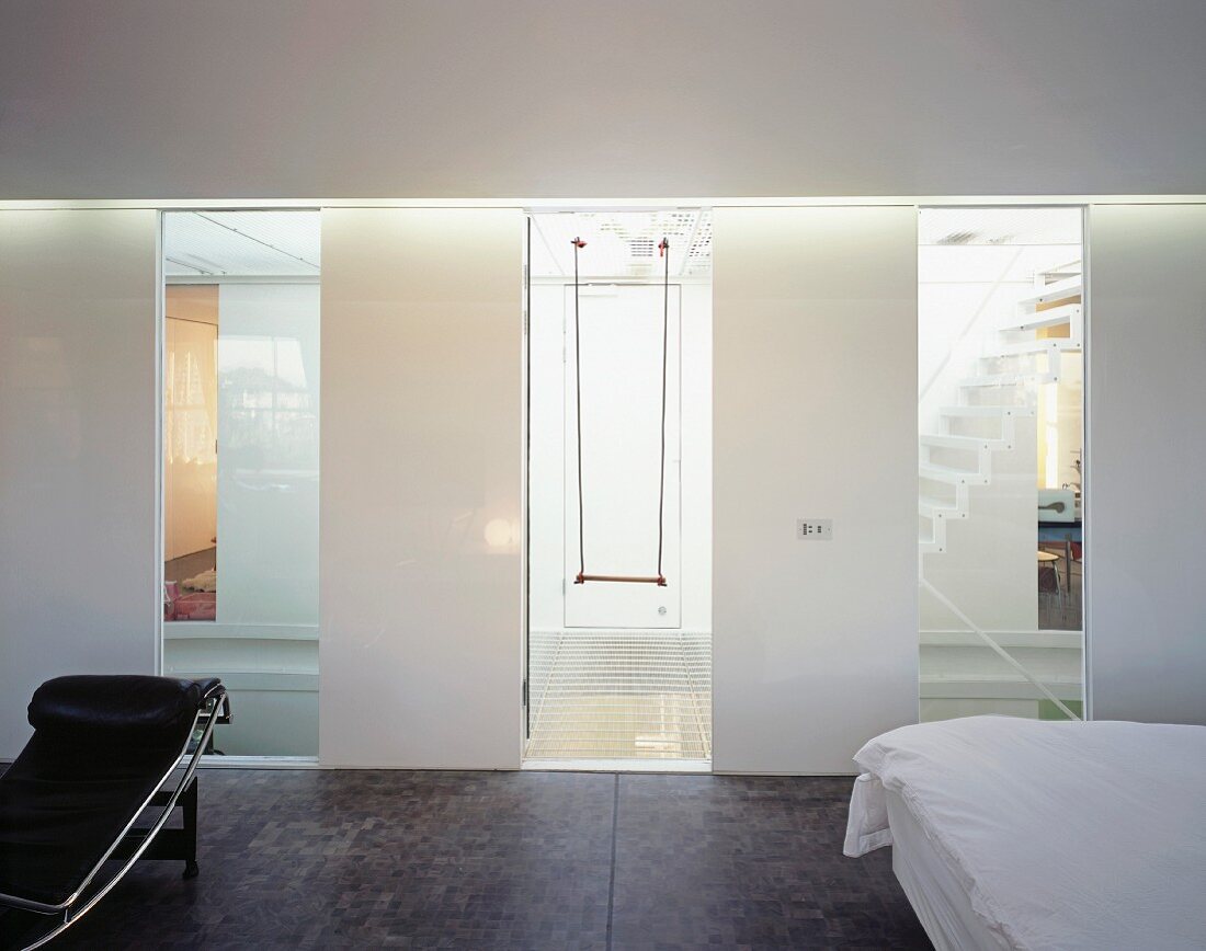 View of swing through stairwell window of designer bedroom