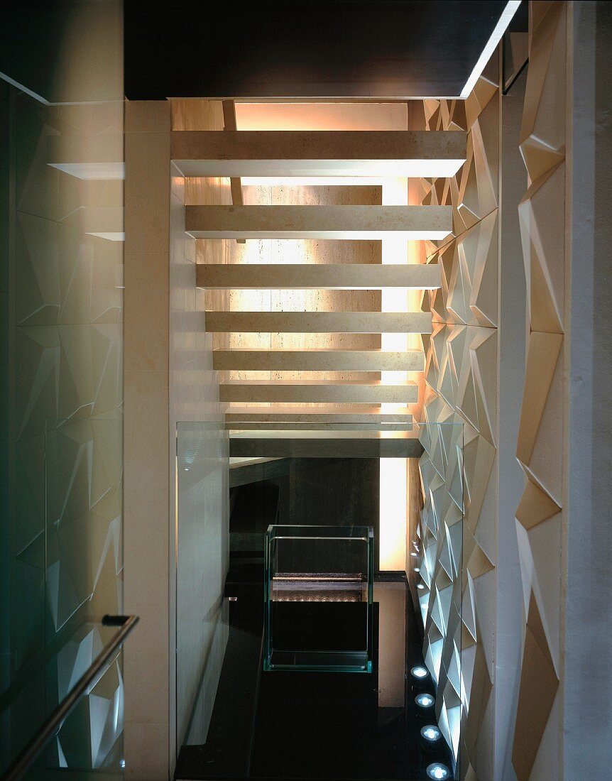 Back view of stairs in narrow stairwell with structured wall