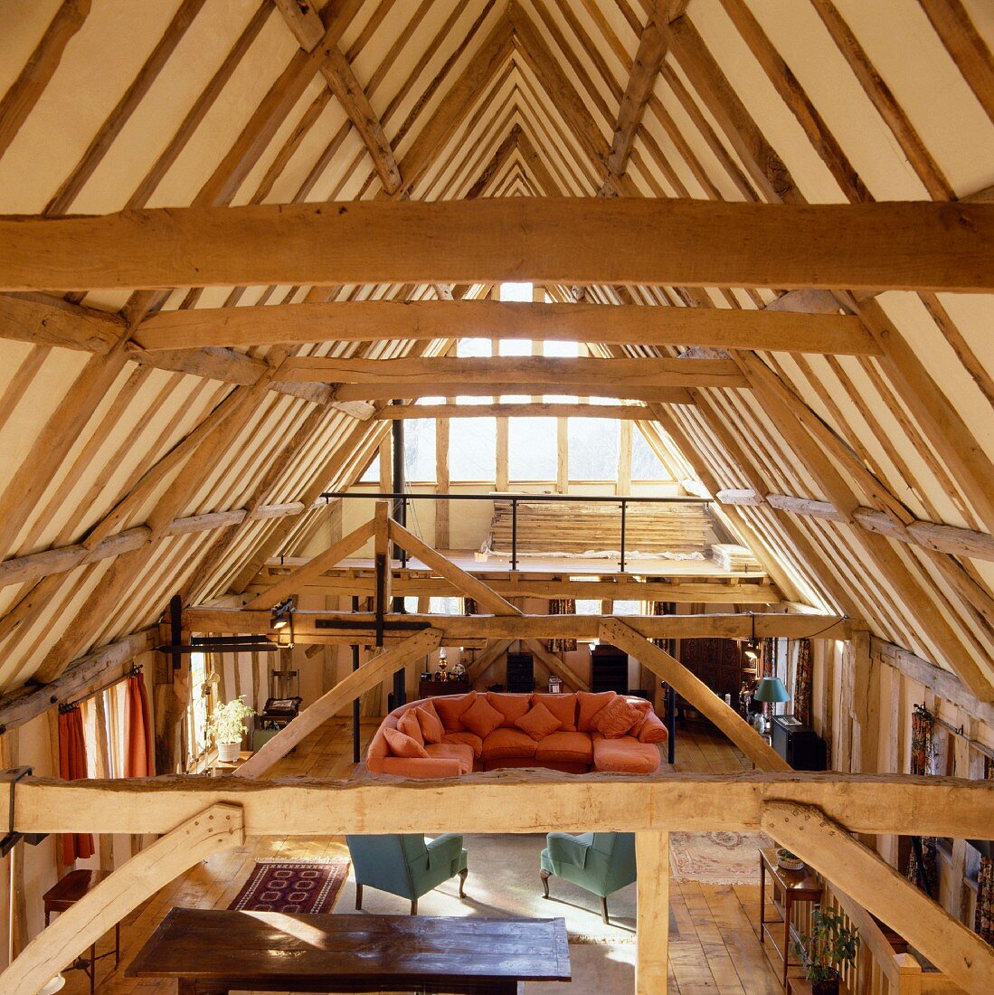 Rustic roof timbers and open-plan living space with wooden support structures