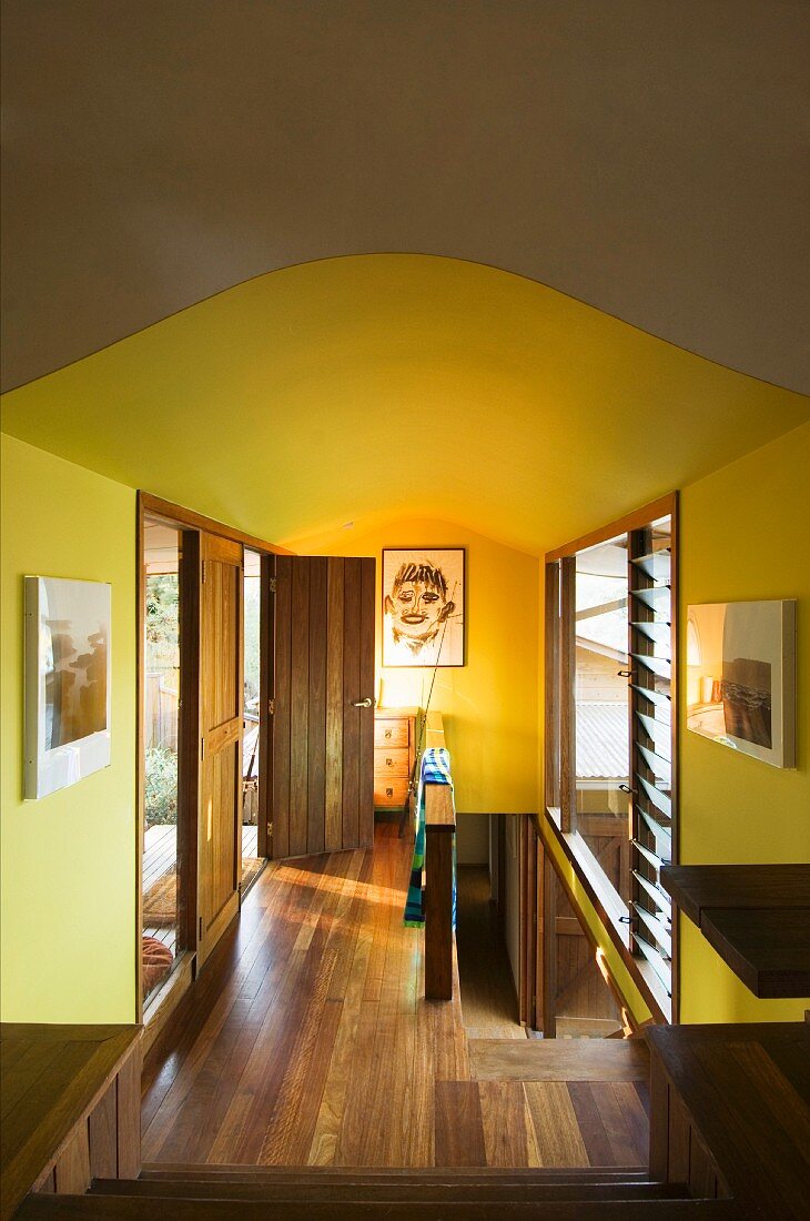 Hallway with wooden floor and yellow walls