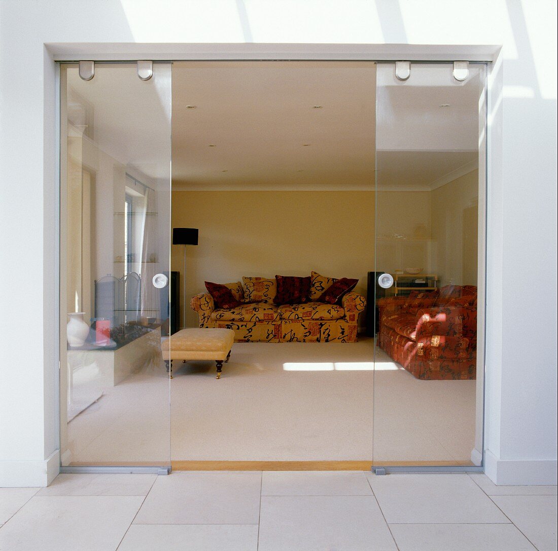 Modern, open, glass sliding terrace doors with view of traditional furniture