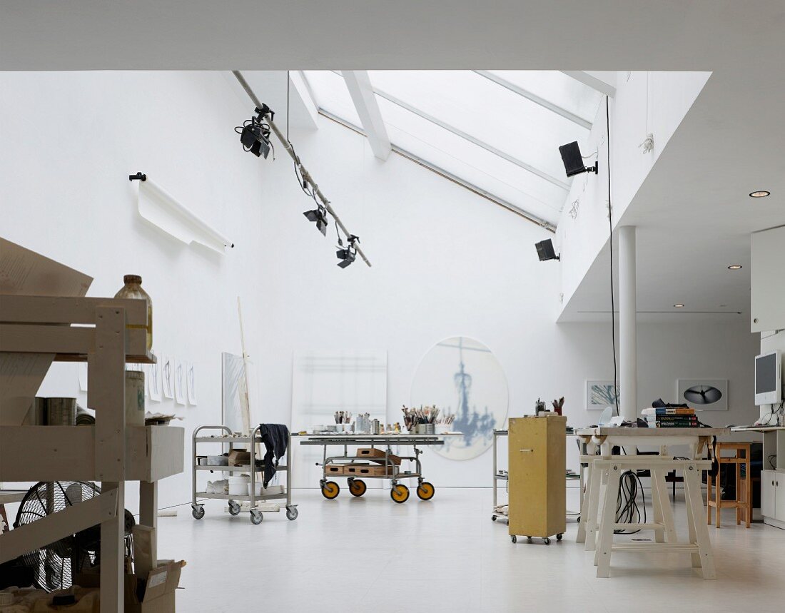 Various trolleys in artist's studio under ceiling with skylights