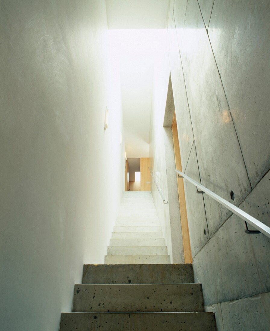 Narrow stairwell with treads and walls of exposed concrete