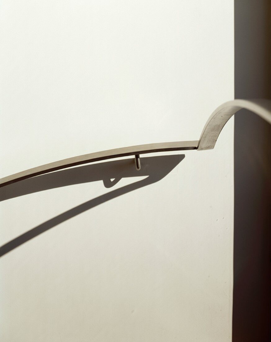 Handrail and its shadow on wall