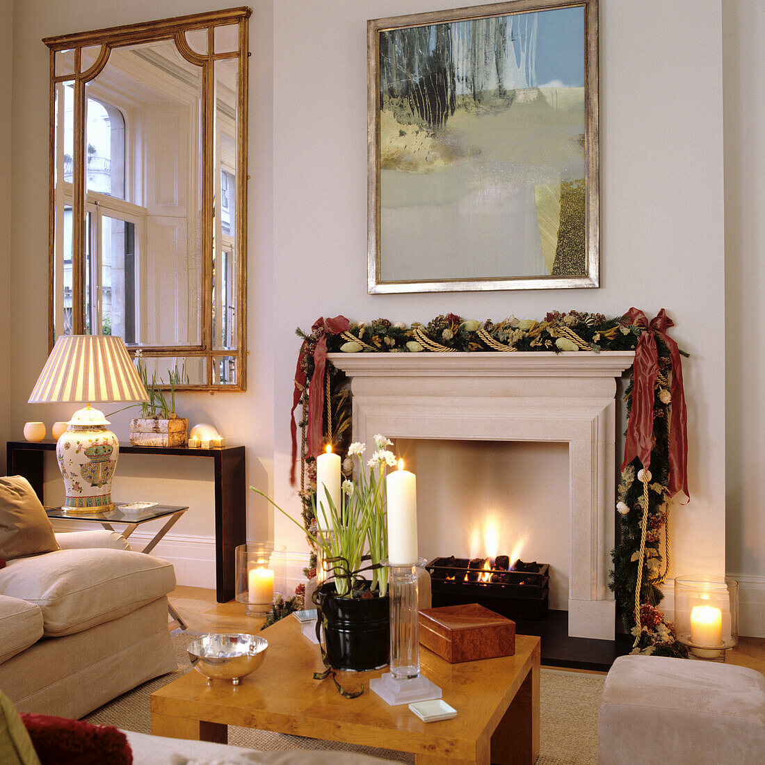 Fireplace with festive garland and artwork in a classic living room