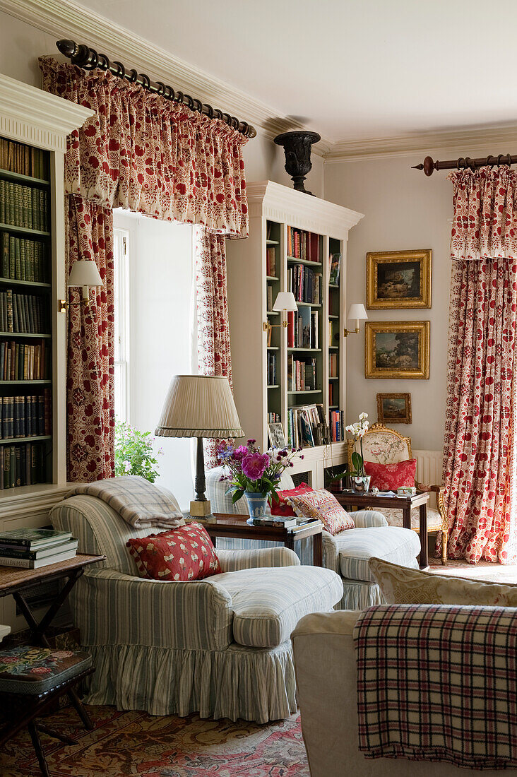 Cosy living room corner with bookshelves and patterned curtains