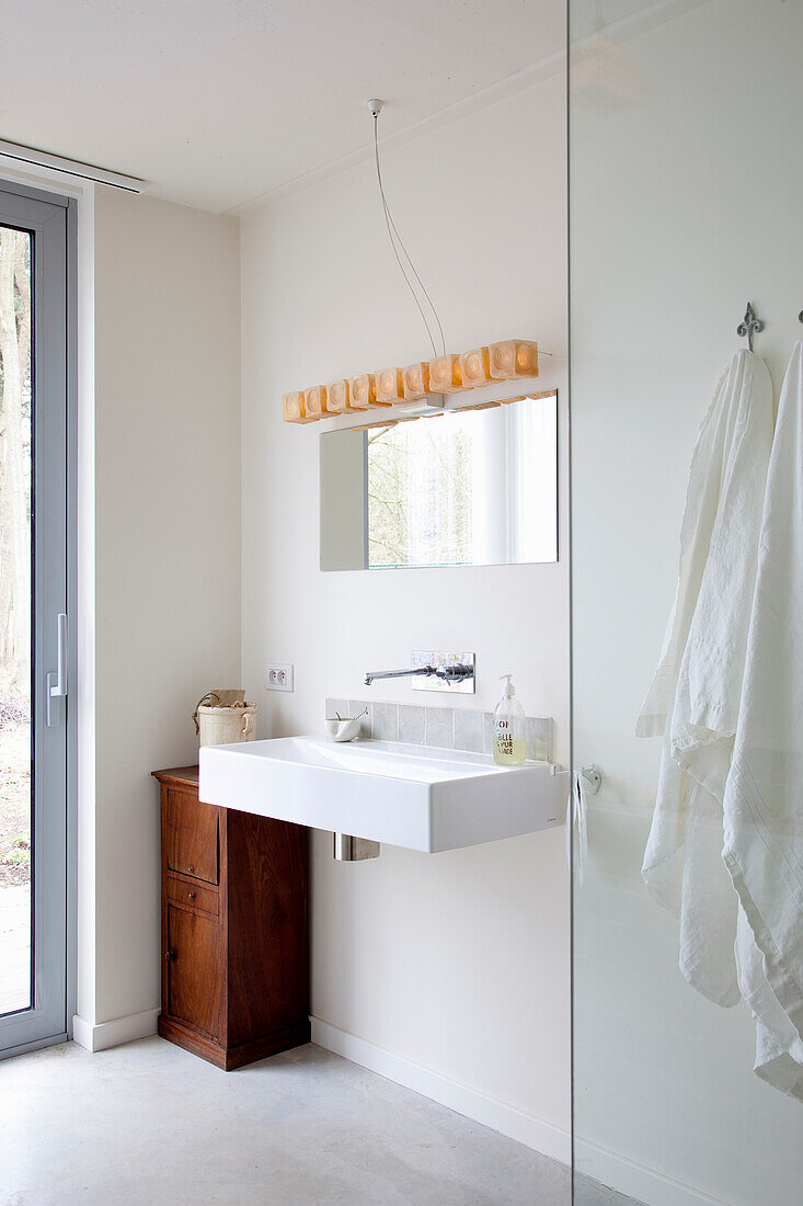 Modern bathroom with rustic wooden cabinet