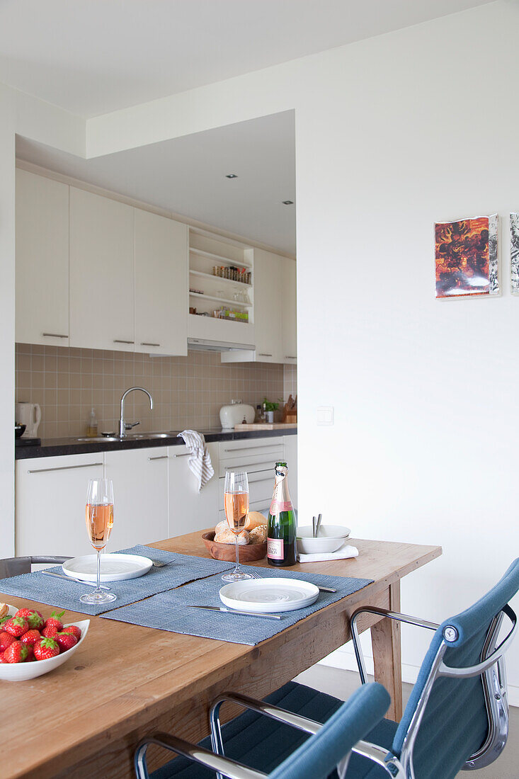 Modern kitchen with dining area and champagne glasses on the table