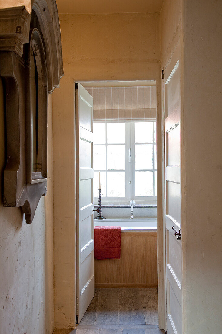 Simple hallway with open door and view into bathroom