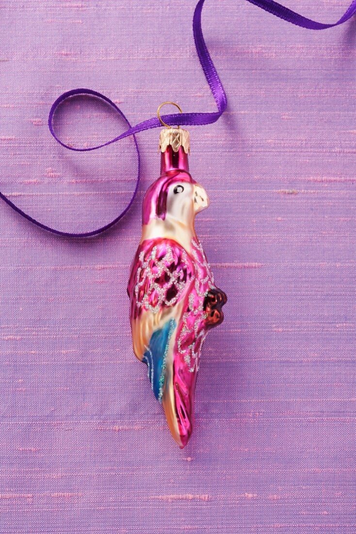A parrot Christmas ornament with a ribbon