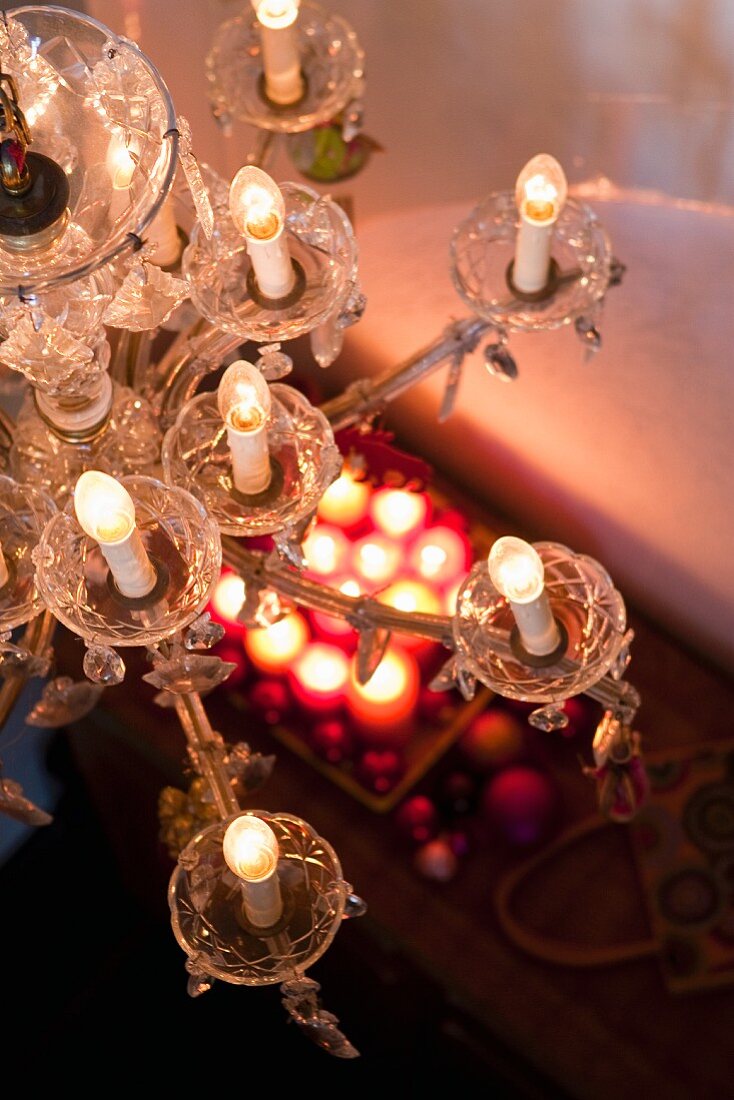 An antique chandelier in a living room decorated for Christmas