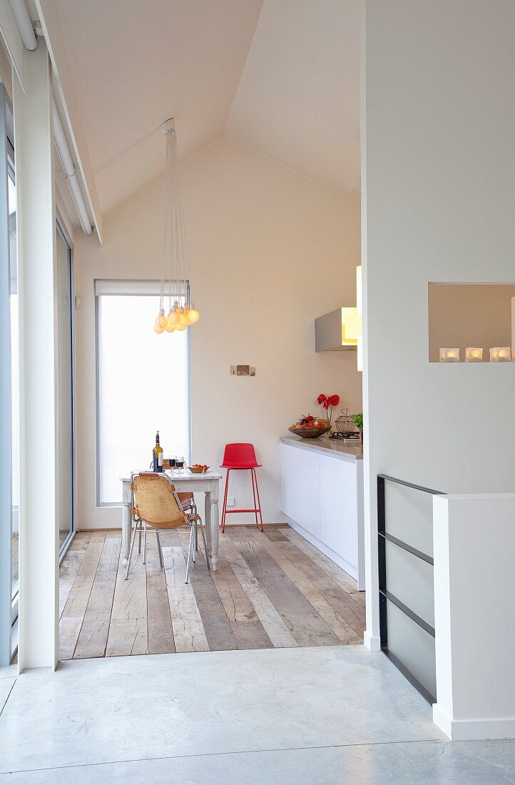 View through floor-to-ceiling doorway into simple kitchen