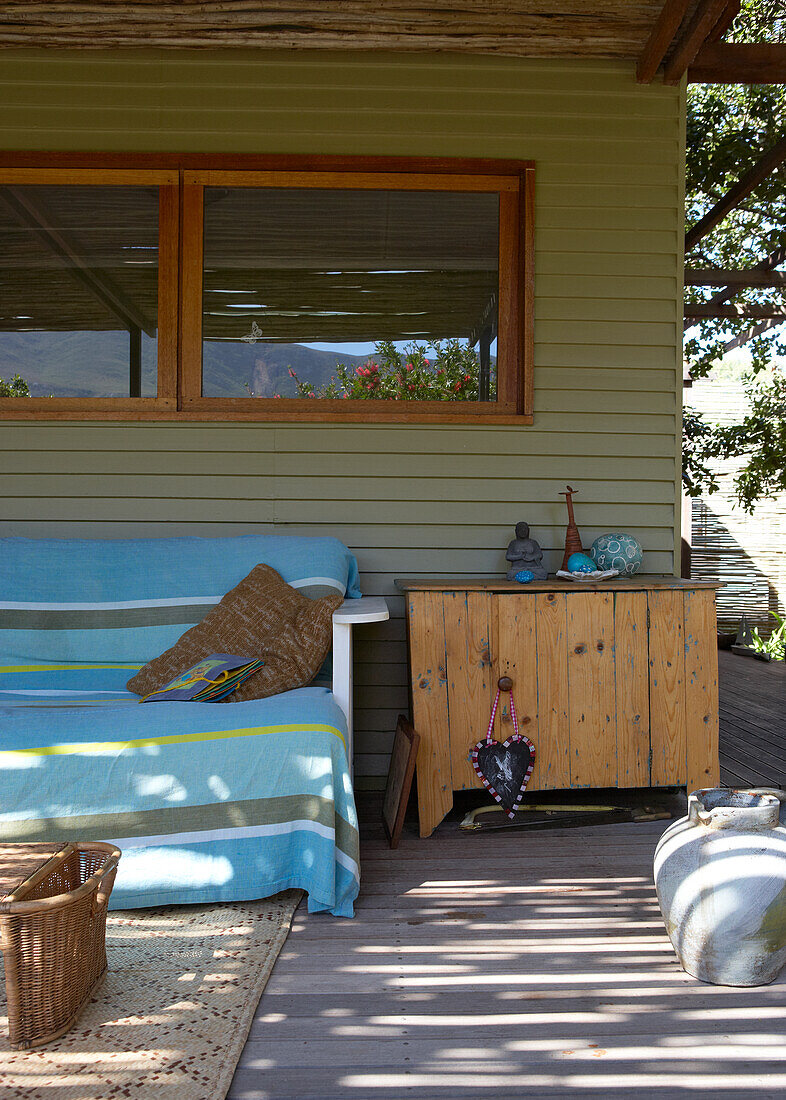 Terrace with wooden furniture, outdoor rug and decoration