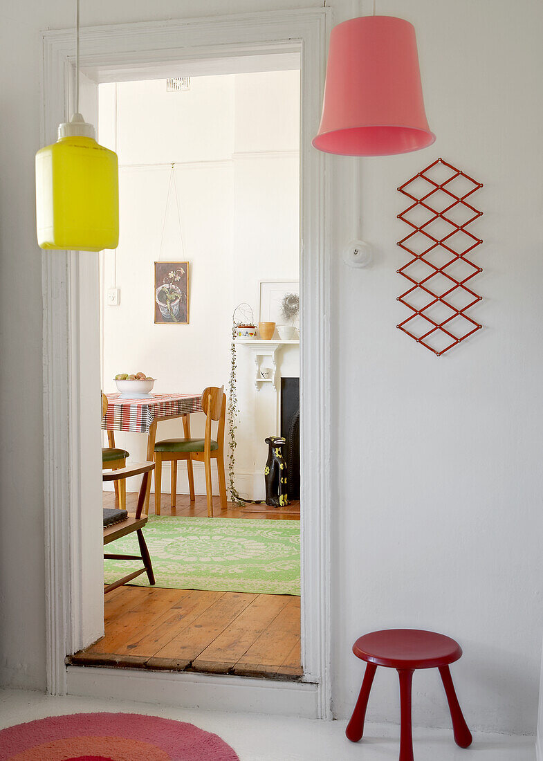 Colourful pendant lights, view of dining table and chairs