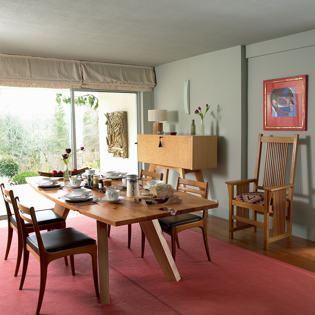 Dining room with wooden furniture and art on the wall