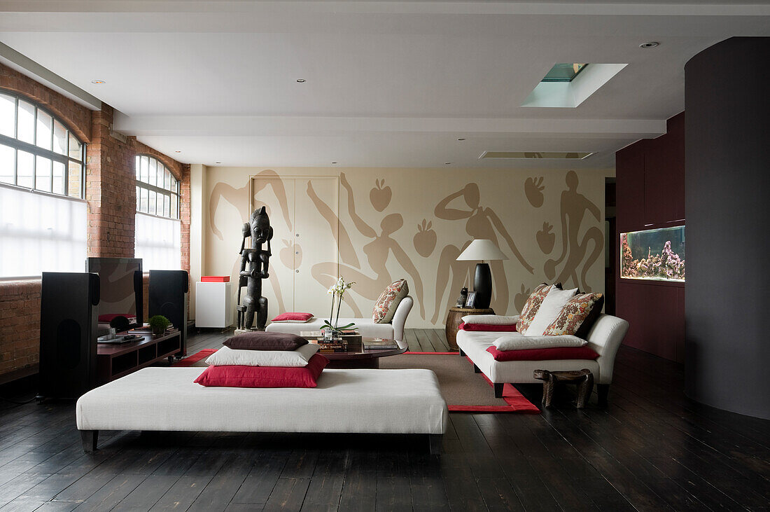 Spacious living area with murals and modern white sofas