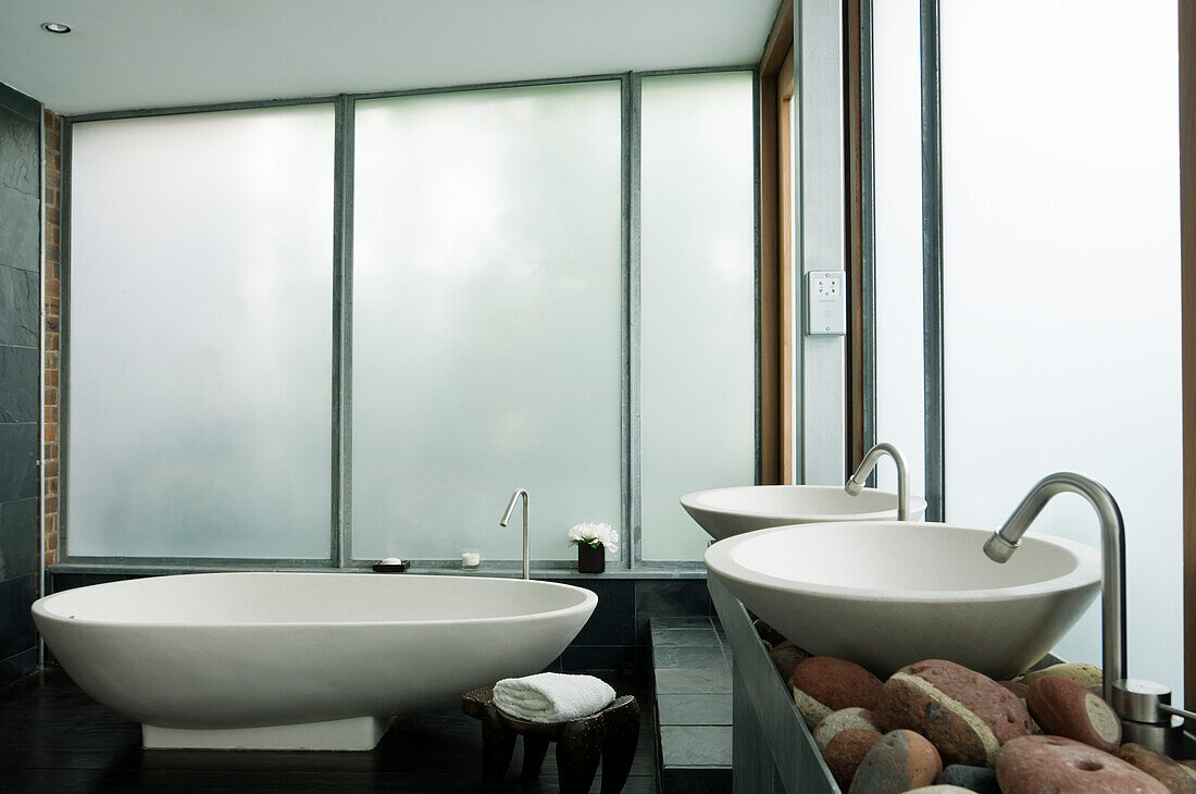 Modern bathroom with freestanding bathtub and round washbasin