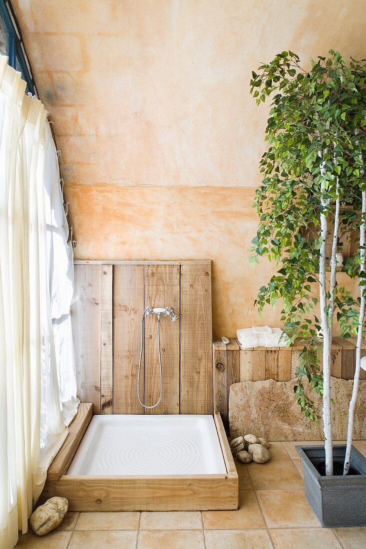 Wood-clad shower base in Mediterranean bathroom