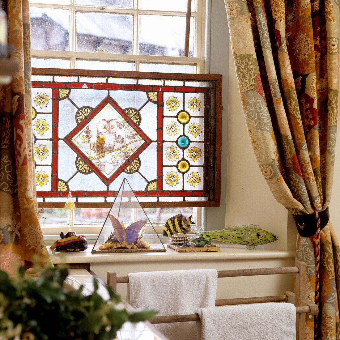 Stained glass window with floral patterns and owl