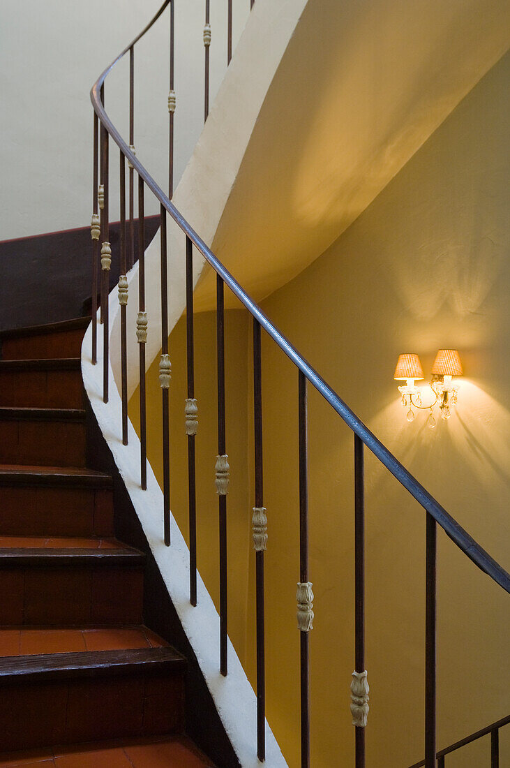 Staircase with wrought-iron banister in artificial light