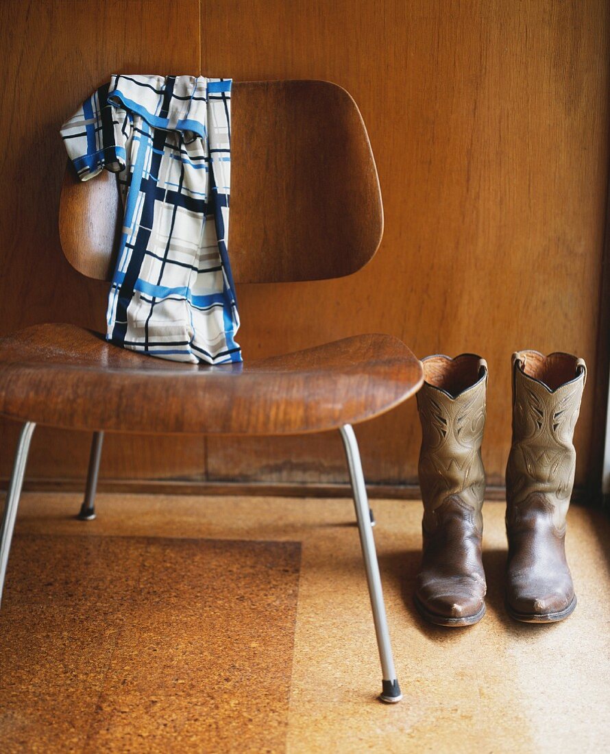 Cowboy boots next to 50s-style chair