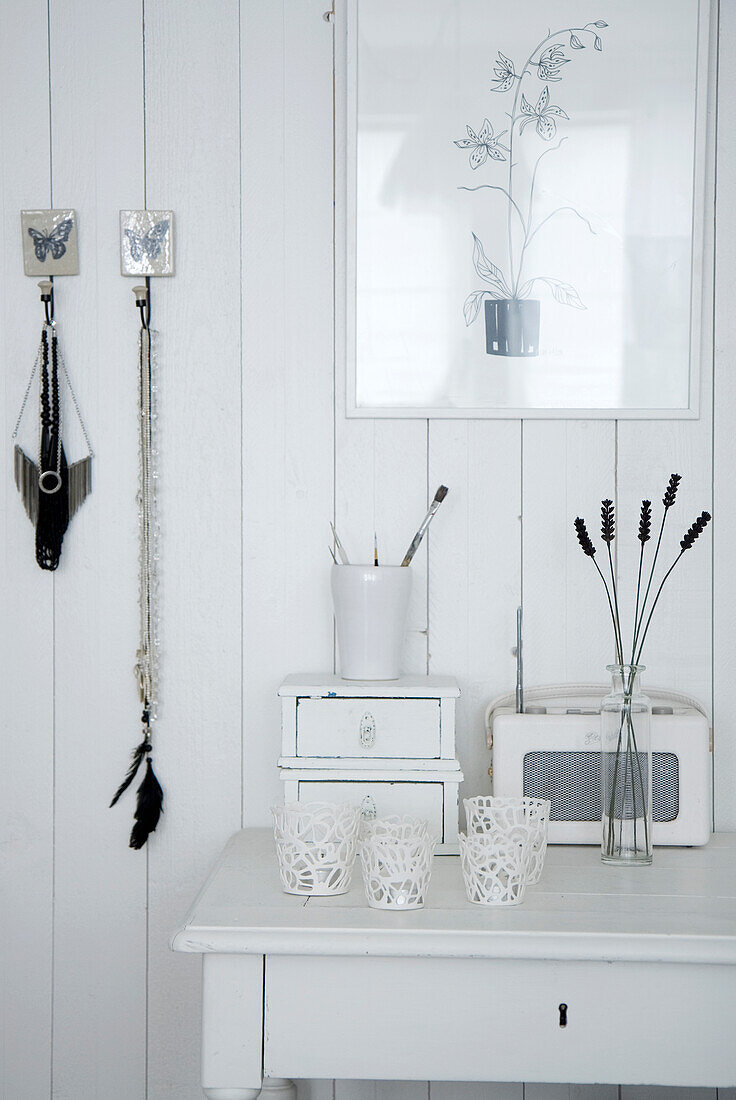 White wall decoration with simple candle holders and retro radio