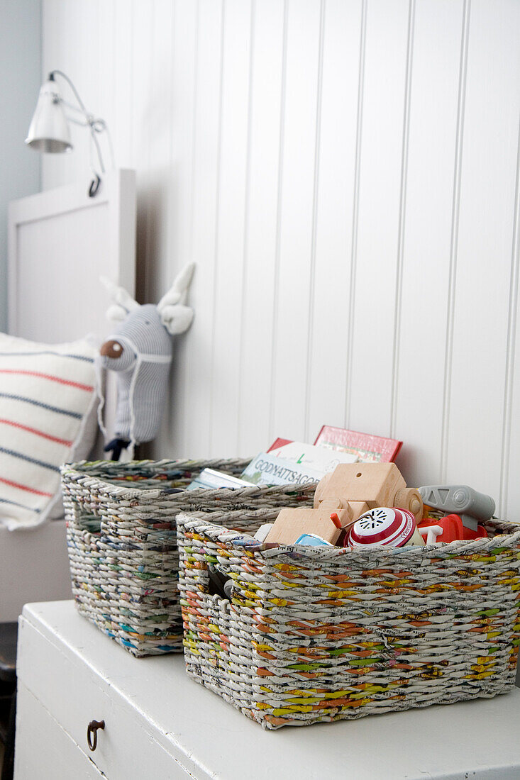 Woven baskets on a white chest of drawers, Scandinavian design