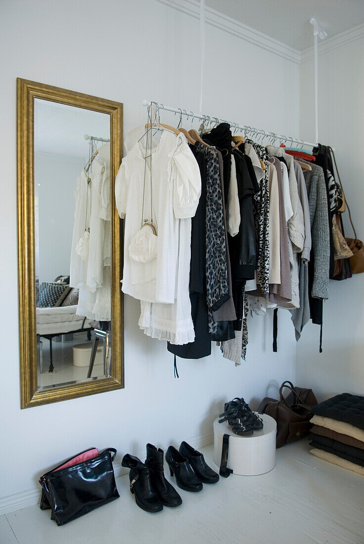 Clothes rack with fashion items and mirror