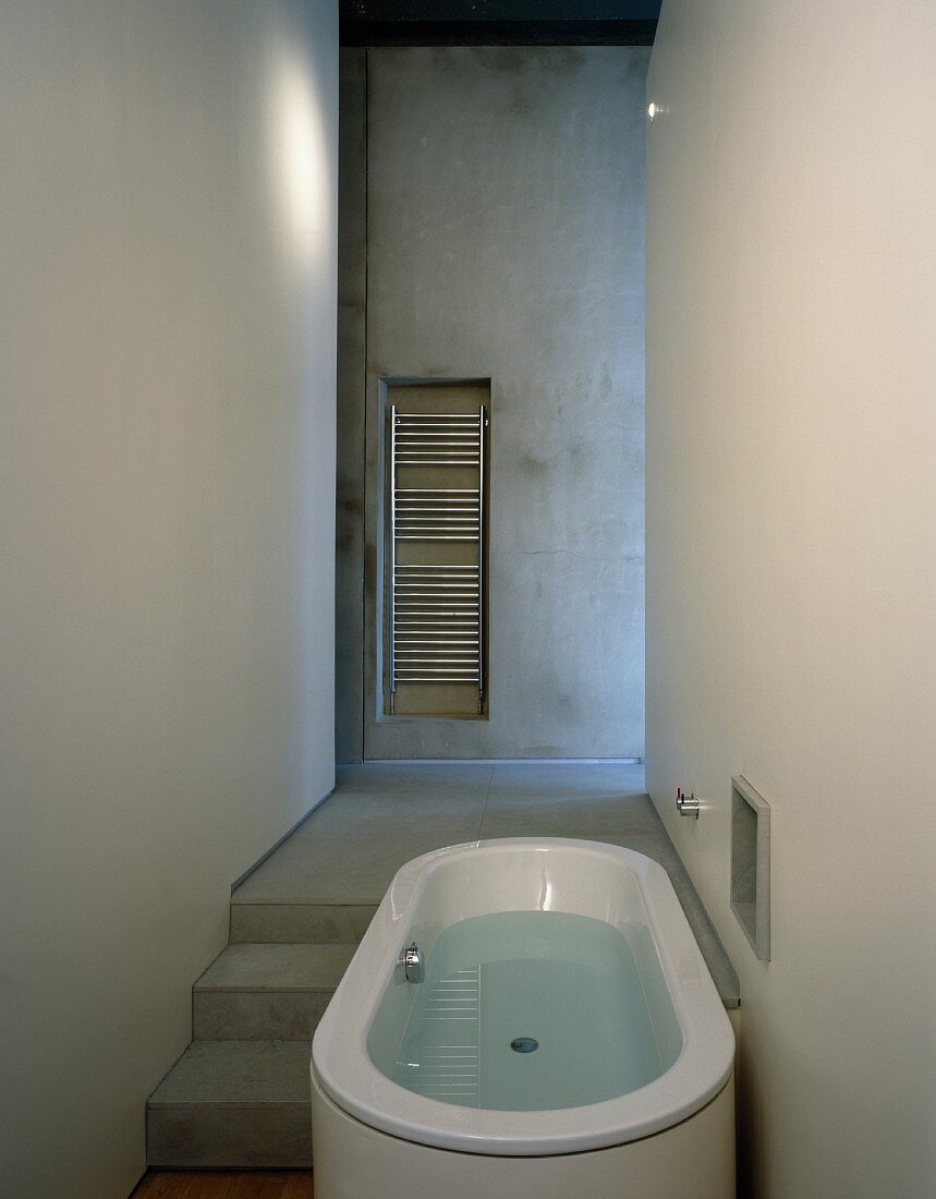 Narrow bathroom with free-standing bathtub