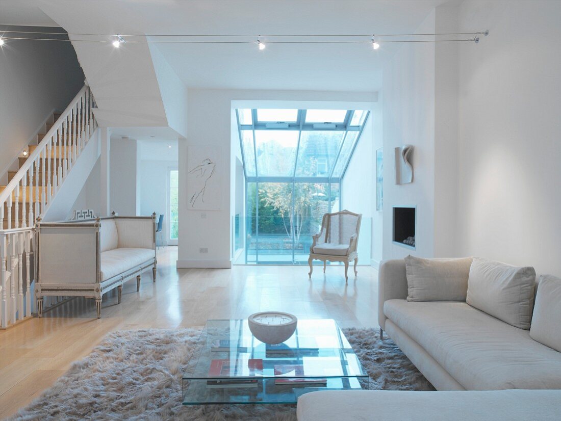 Living room with white walls and white seating