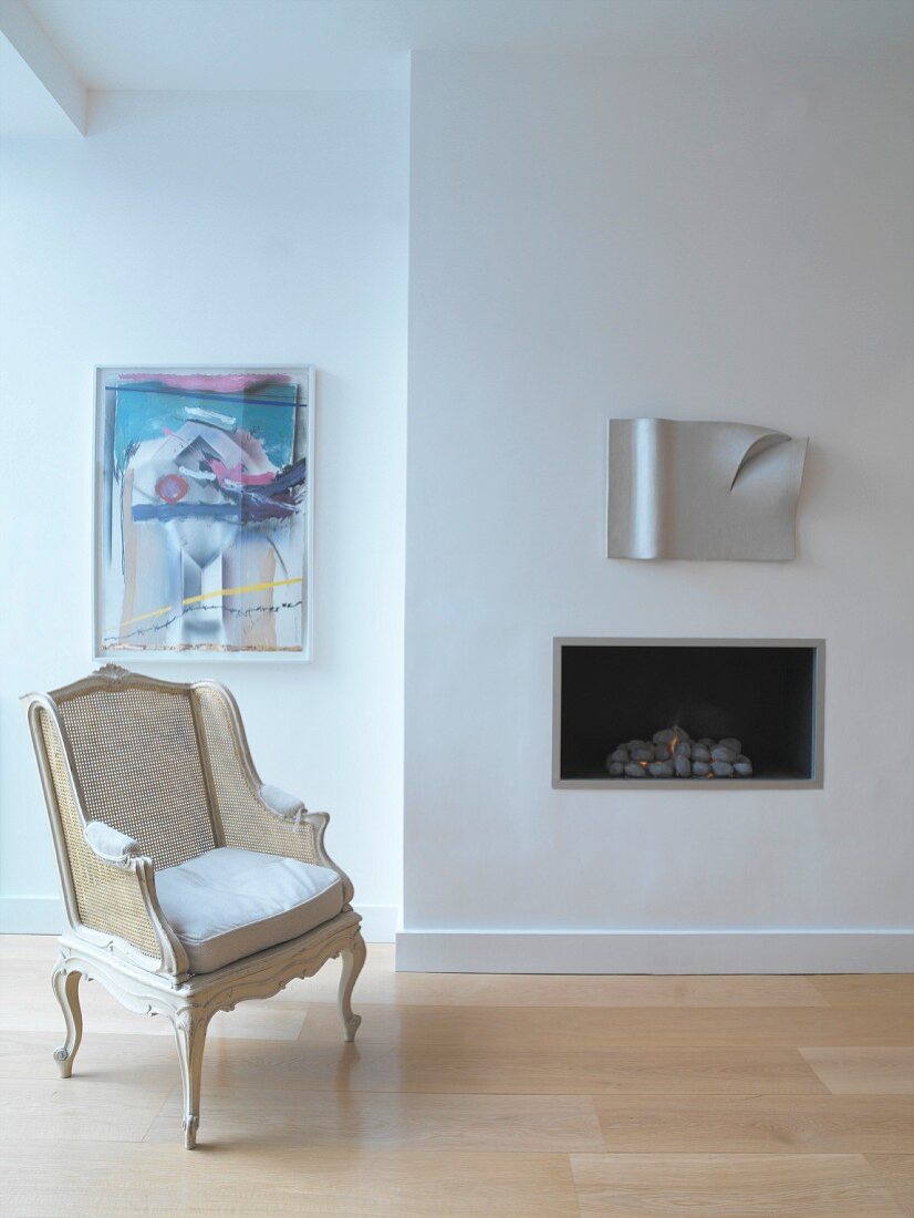 Armchair in front of built-in fireplace
