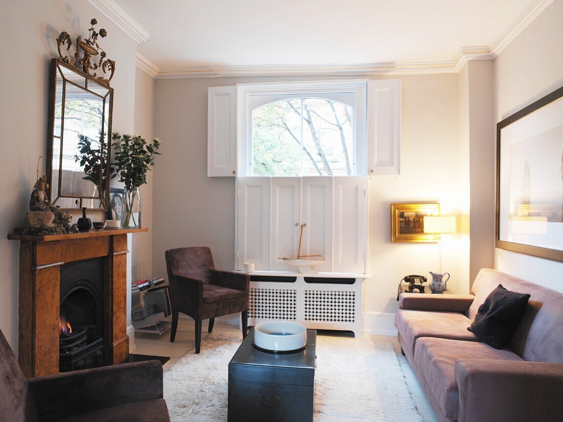 A tartan throw and a chintz loose covers ring the changes in this cosy white-painted living room