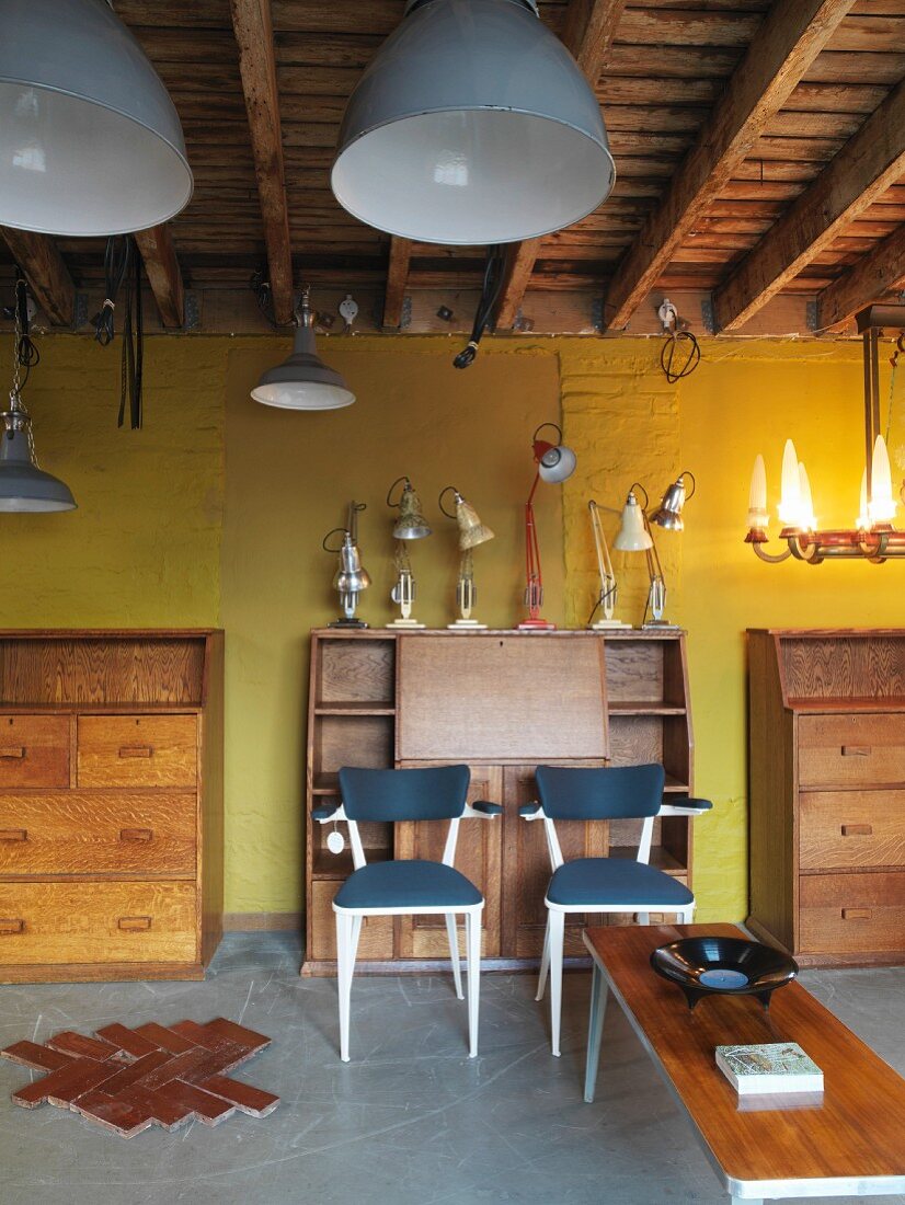Bureau and chests of drawers in front of yellow wall