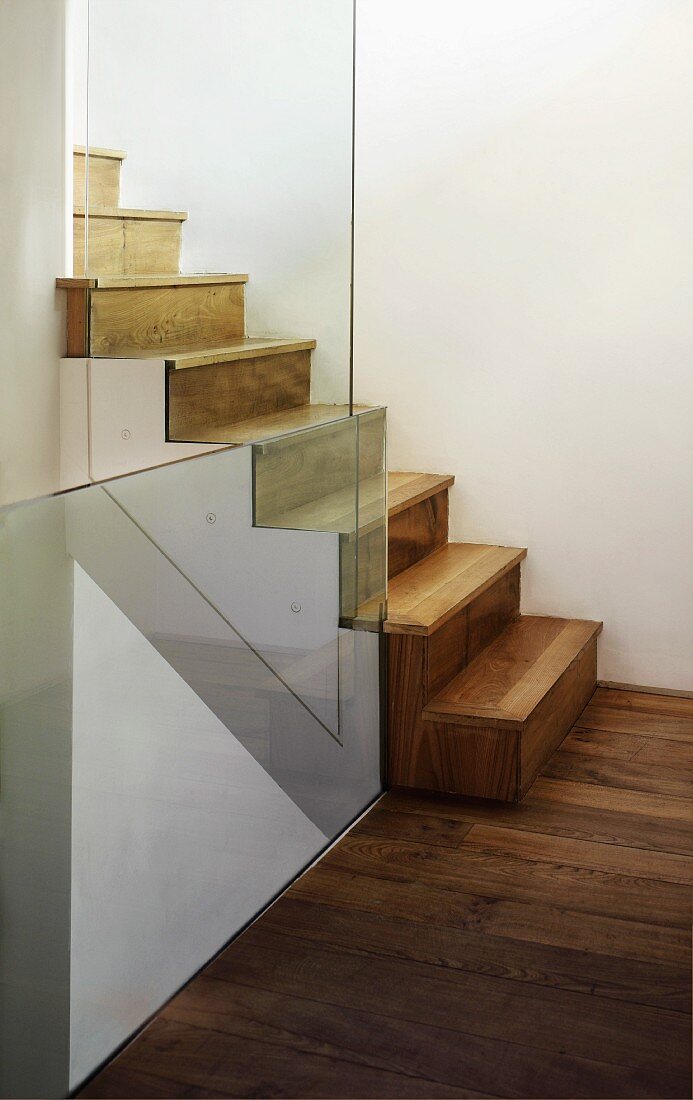 Stairwell with wooden stairs & glass balustrade