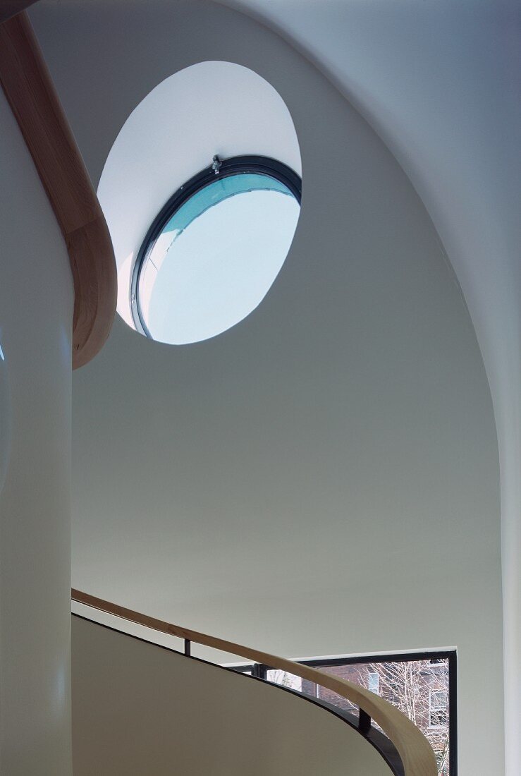 Stairwell with spiral staircase & round window